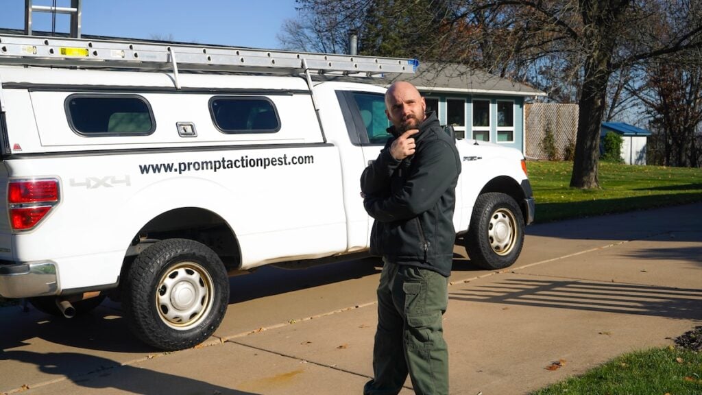 Prompt action employee poses in front of branded van