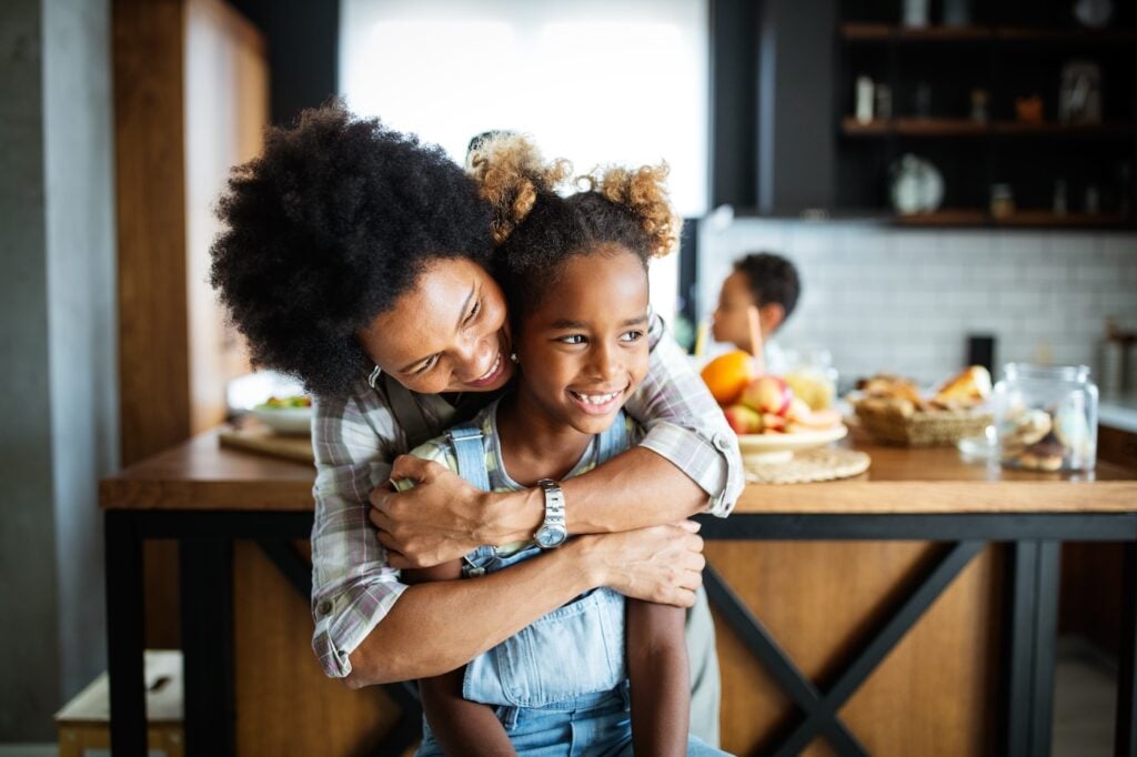 Happy mother and children in kitchen. Healthy food, family, cooking concept