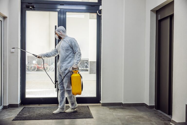 Sanitizing interior surfaces. Cleaning and Disinfection inside buildings, the coronavirus epidemic. Professional teams for disinfection efforts. Infection prevention and control of epidemic. Protective suit and mask.